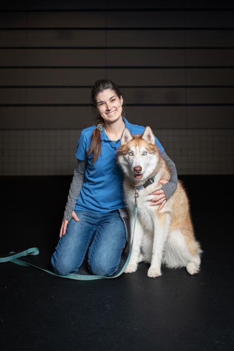 Emily H, a dog trainer at Animal Humane Society, poses with her dog
