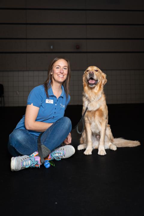 Katie, a dog trainer at Animal Humane Society, poses with her dog
