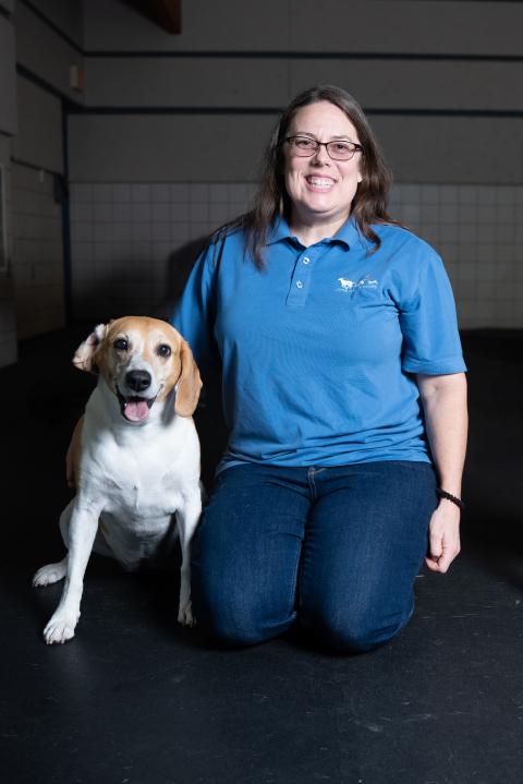 Angie K, a dog trainer at Animal Humane Society, poses with her dog