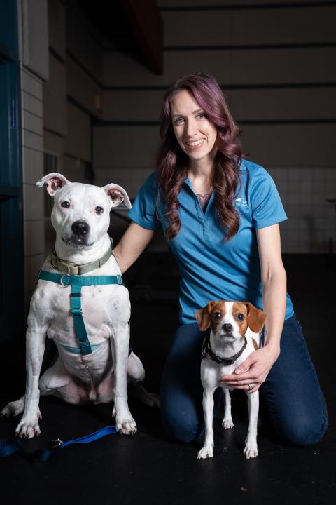 Jaceil, a dog trainer at Animal Humane Society, poses with her two dogs