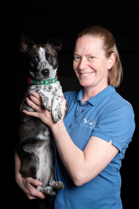 Laura, a dog trainer at Animal Humane Society, poses with her dog