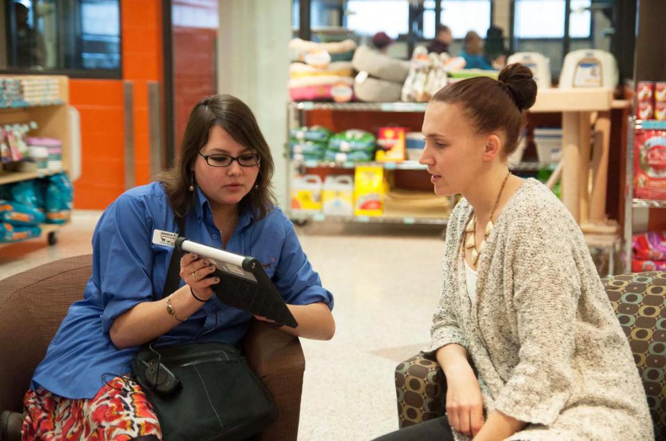 An AHS employee helps a customer through the adoption process
